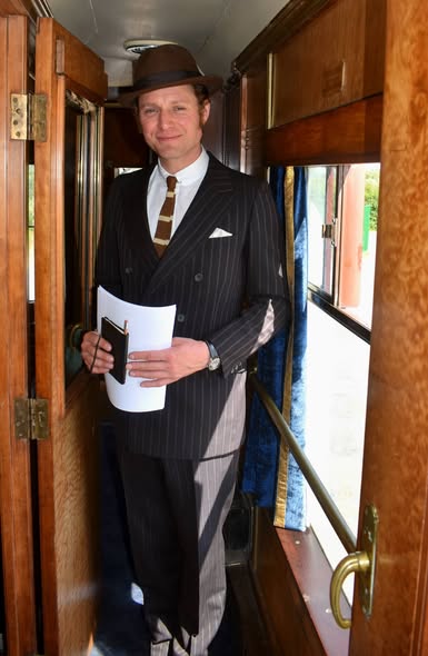An actor in character in the carriage corridor